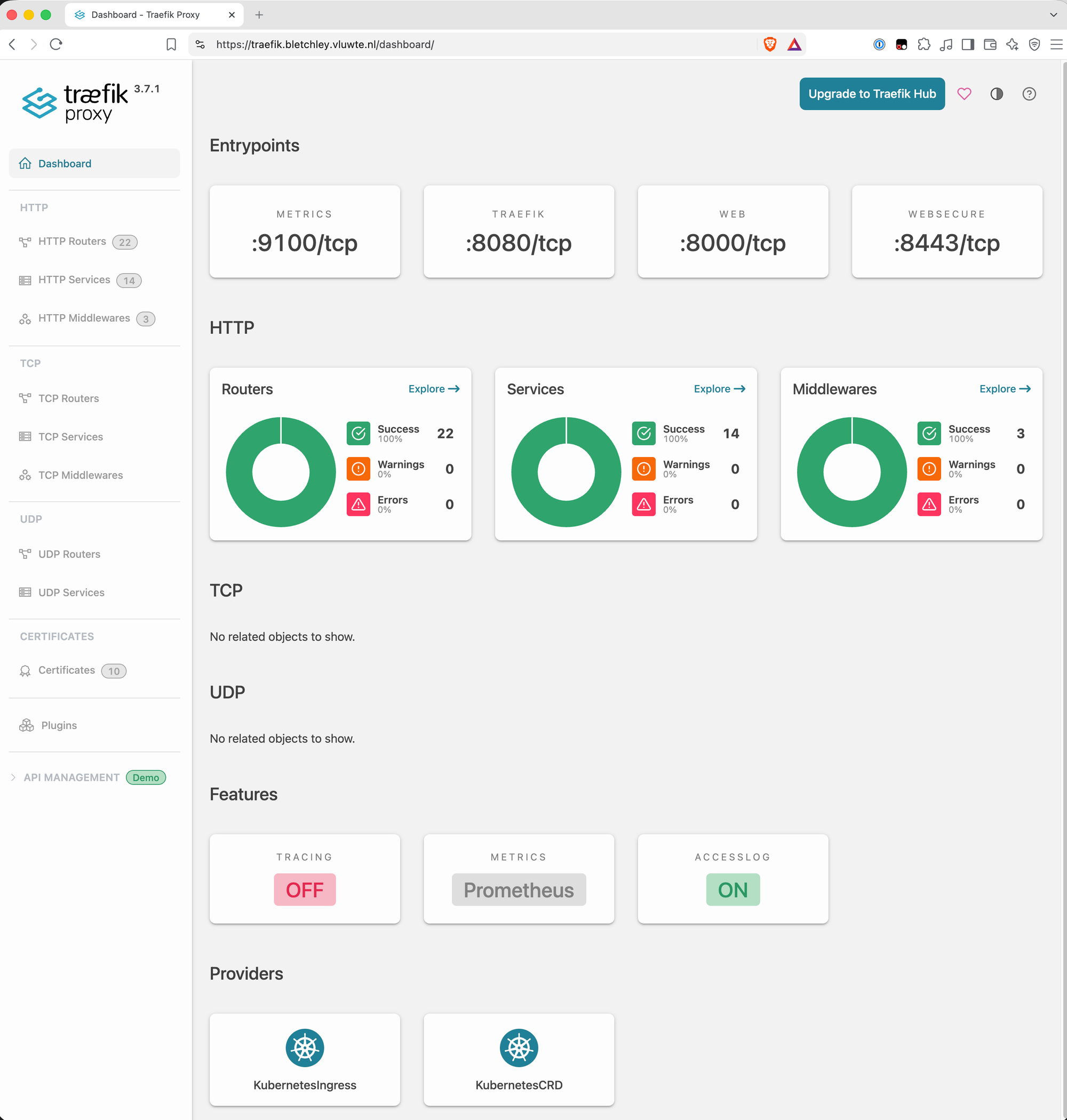 The Traefik 3.7.1 dashboard at https://traefik.bletchley.vluwte.nl/dashboard/. The entrypoints row lists metrics on port 9100, traefik on 8080, web on 8000 and websecure on 8443. HTTP shows 22 routers, 14 services and 3 middlewares, each at 100 percent success with no warnings and no errors. The sidebar lists 10 certificates. The features row shows tracing off, metrics via Prometheus and the access log on, and the providers are KubernetesIngress and KubernetesCRD.